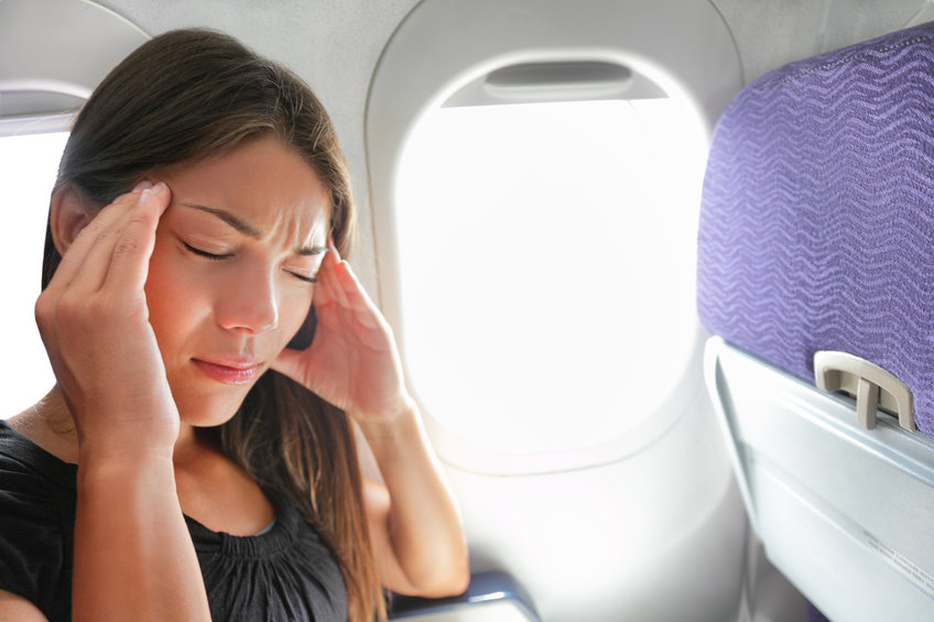 Person with a headache on an airplane