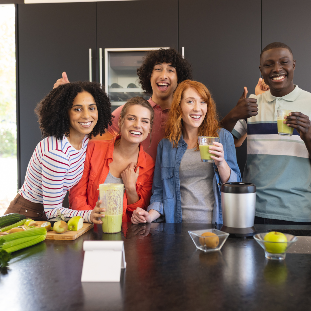 Group of young people standing in kitchen